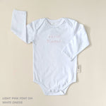TinyBitz Custom baby onesie in white with name embroidery, unique outfit for baby’s birth announcement or first photoshoot.