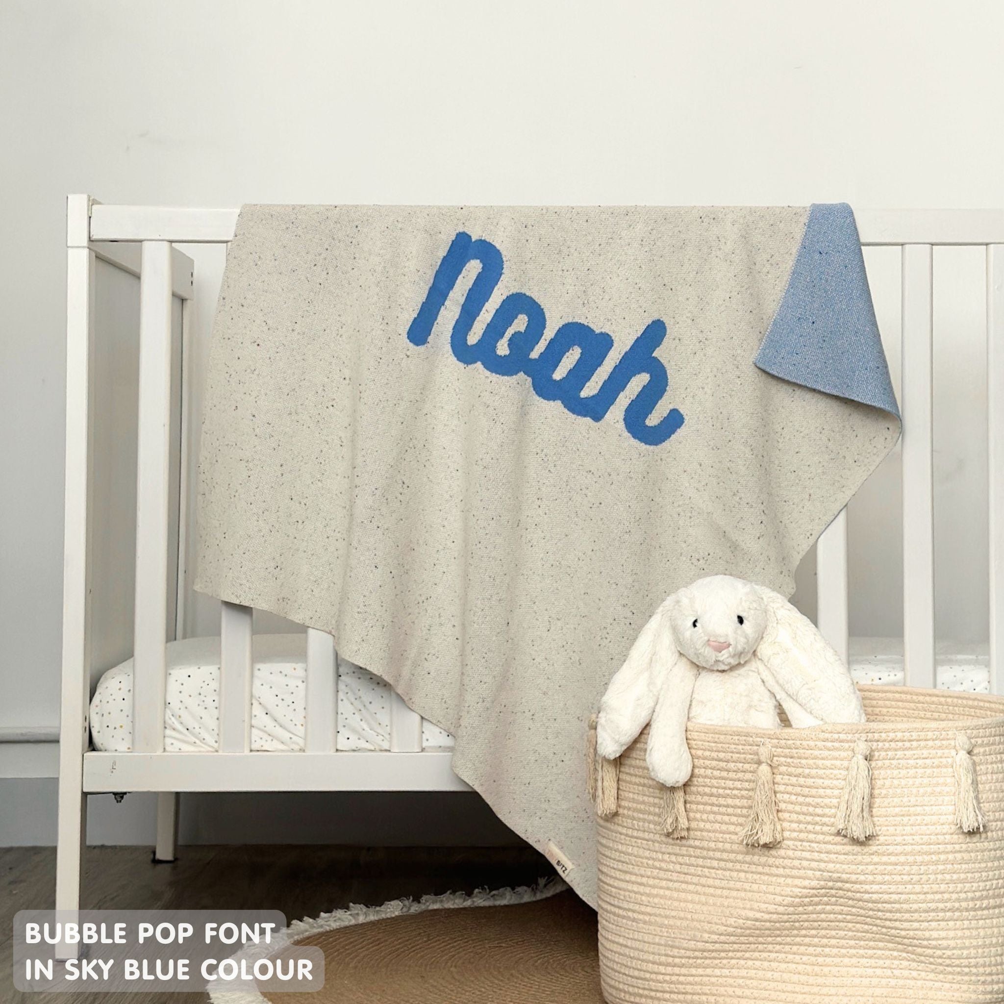 TinyBitz personalized name blanket in cream and sky blue with a confetti pattern, perfect gift for newborn babies and kids.