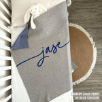 Knitted baby blanket in grey and blue with a confetti pattern, customised with baby's name, made by TinyBitz.