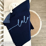 Cotton baby blanket with baby's name knitted in navy and sky blue with a confetti pattern, made by TinyBitz.