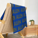 Customisable blanket with adult's name knitted in blue and army green, personalized by TinyBitz.