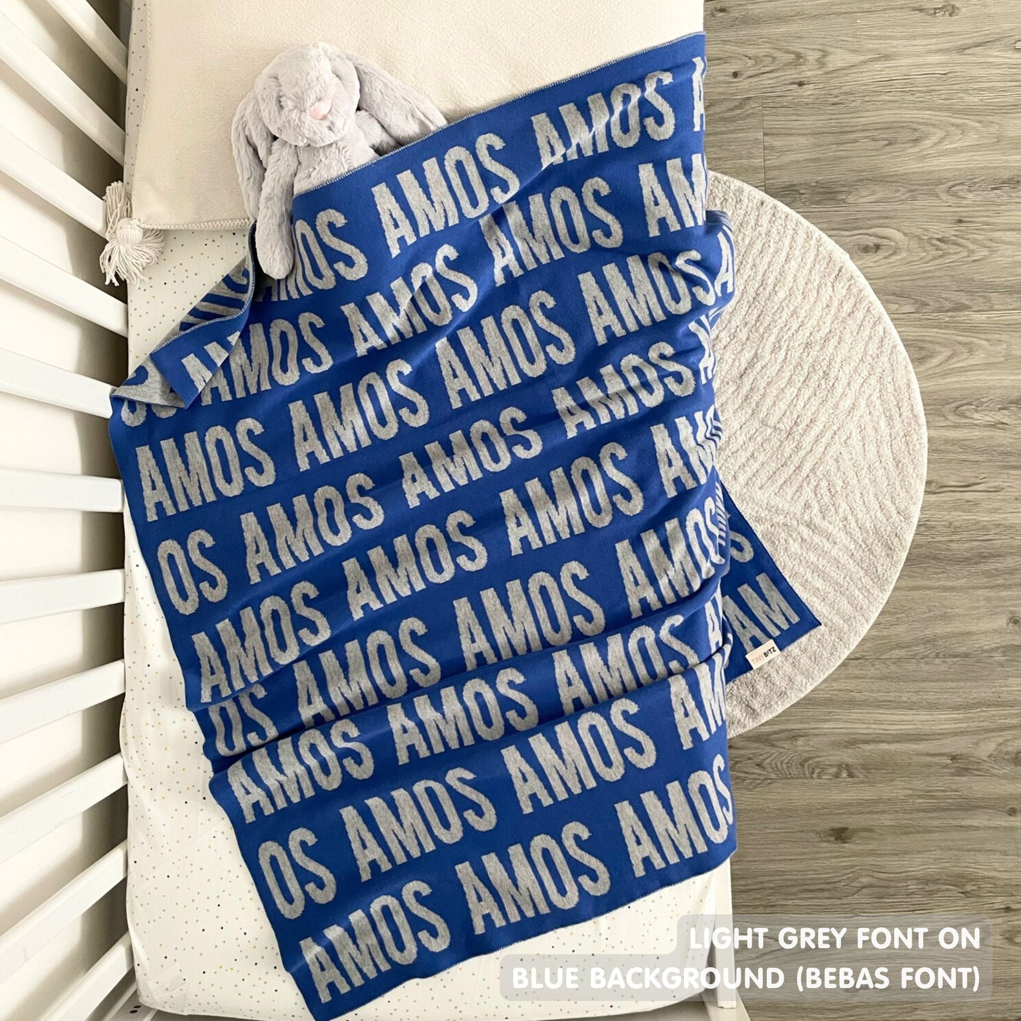 Baby blanket knitted from cotton personalized with baby's name in blue and light grey, made by TinyBitz.