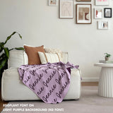 Custom name blanket draped on sofa, knitted in light purple and eggplant makes the best personalised home decor.