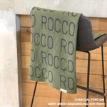 Customisable blanket with adult's name knitted in army green and charcoal, personalized by TinyBitz.