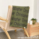 Customisable blanket with adult's name knitted in army green and navy, personalized by TinyBitz.