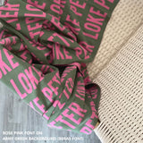 Personalised blanket for adult knitted from cotton in army green and rose pink, custom made by TinyBitz.