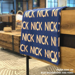 Custom name blanket in blue and peach draped over a chair makes the best personalized home decor.