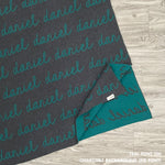 Baby blanket knitted from cotton personalized with baby's name in charcoal and teal, made by TinyBitz.