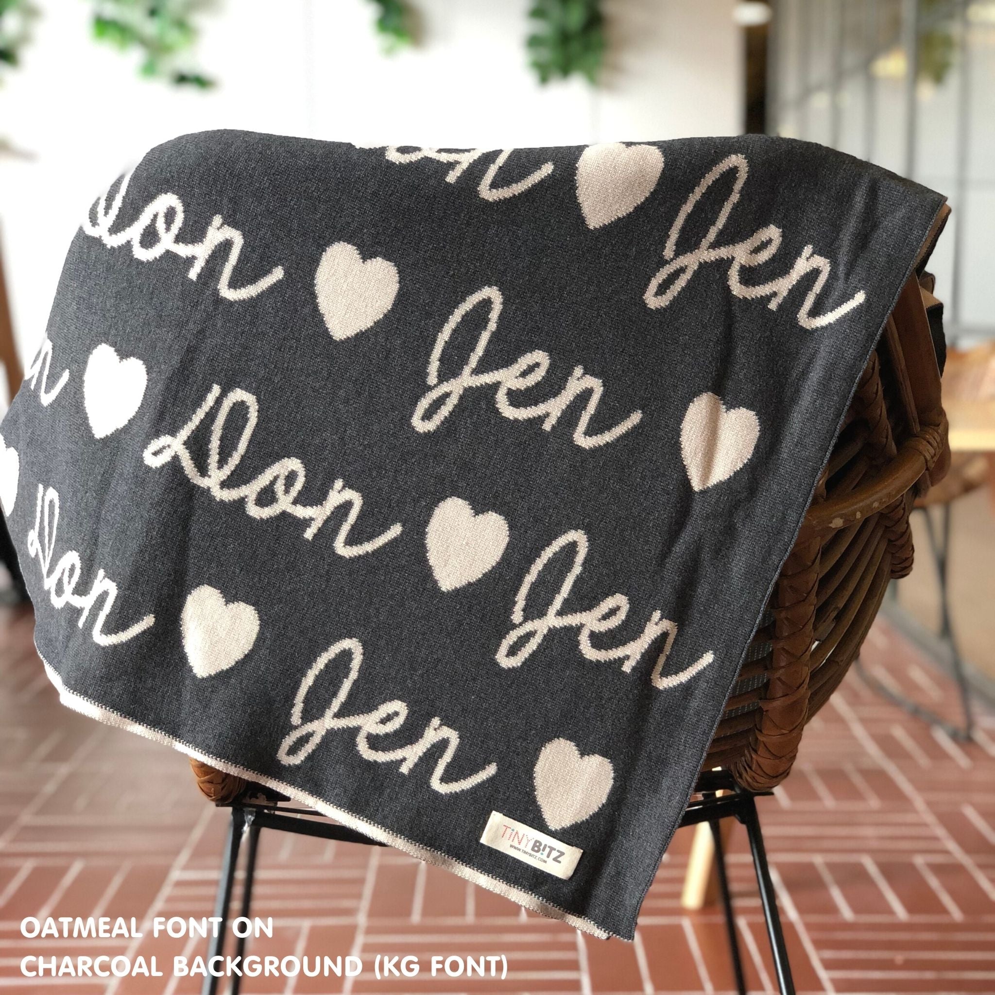 TinyBitz custom name blanket with couple's name knitted in charcoal and oatmeal, making the perfect wedding or anniversary gift!