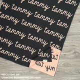 TinyBitz knitted name blanket in charcoal and peach can be used to decorate your baby's room!