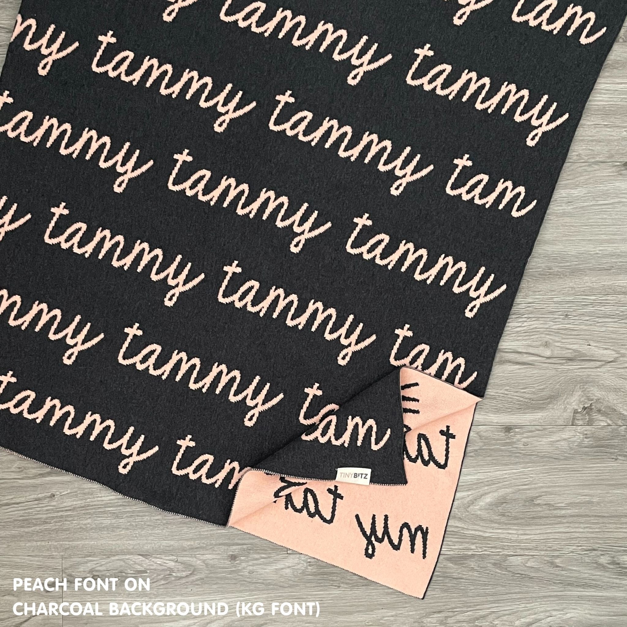 TinyBitz knitted name blanket in charcoal and peach can be used to decorate your baby's room!