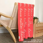 Customisable blanket with adult's name knitted in coral and oatmeal, personalized by TinyBitz.