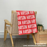 TinyBitz personalized knitted blanket in coral background, customized with baby's name and made from 100% cotton.
