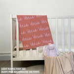 TinyBitz knitted baby girls blanket in dusty pink background and light purple, personalized with your baby’s name.