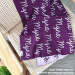 TinyBitz personalized knitted blanket in eggplnat background, customized with baby's name and made from 100% cotton.