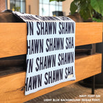 Custom name blanket in light blue and navy draped over a chair makes the best personalized home decor.