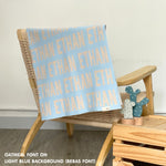 Cotton Kids Blanket with name knitted in light blue and oatmeal, made by TinyBitz.