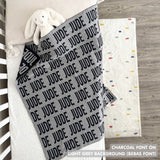 Cotton baby blanket with baby's name knitted in light grey and charcoal, made by TinyBitz.