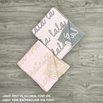 TinyBitz personalized knitted blanket in light pink background, customized with baby's name and made from 100% cotton.