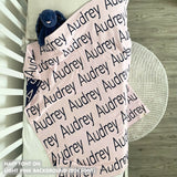 Baby blanket knitted from cotton personalized with baby's name in light purple and navy, made by TinyBitz.