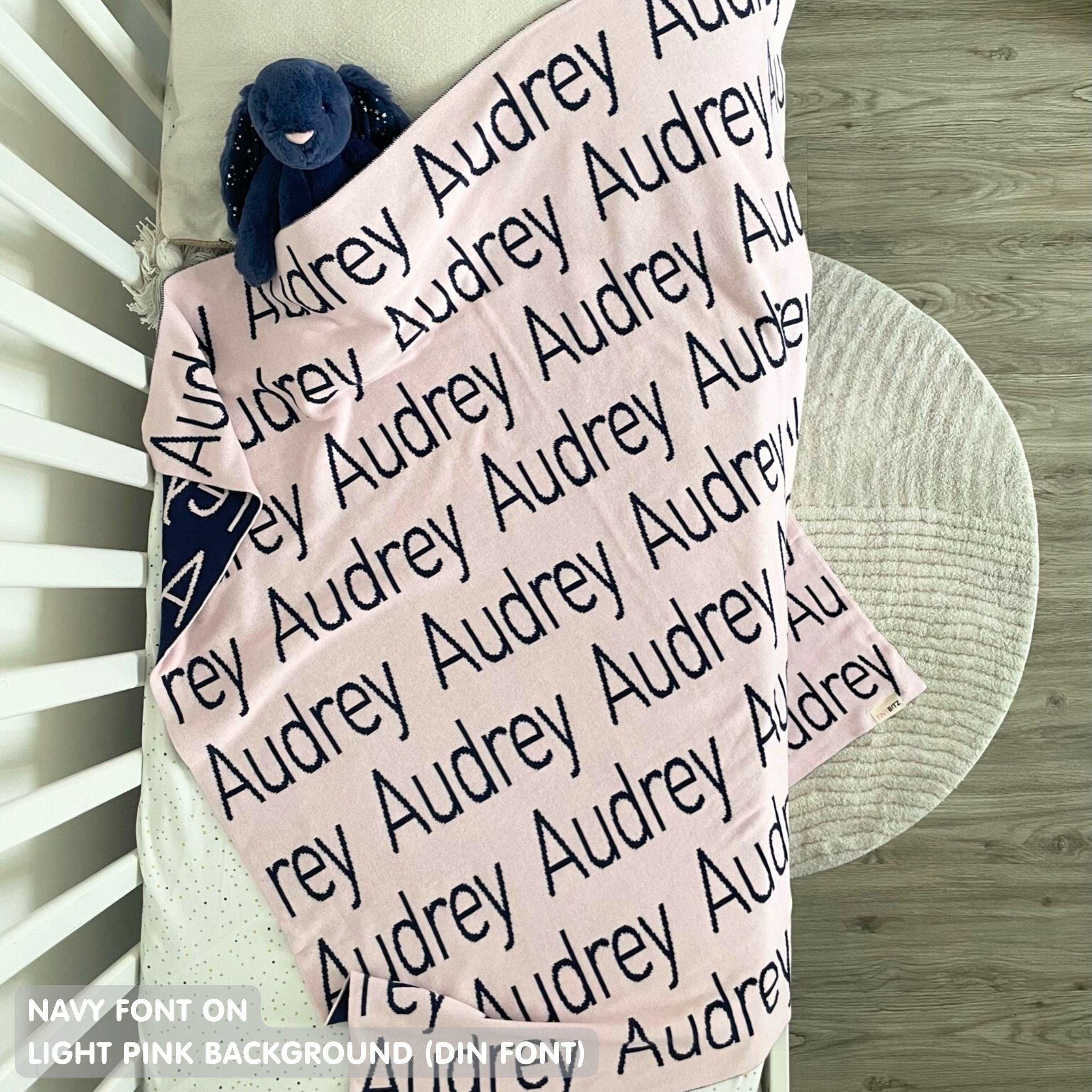 Baby blanket knitted from cotton personalized with baby's name in light purple and navy, made by TinyBitz.