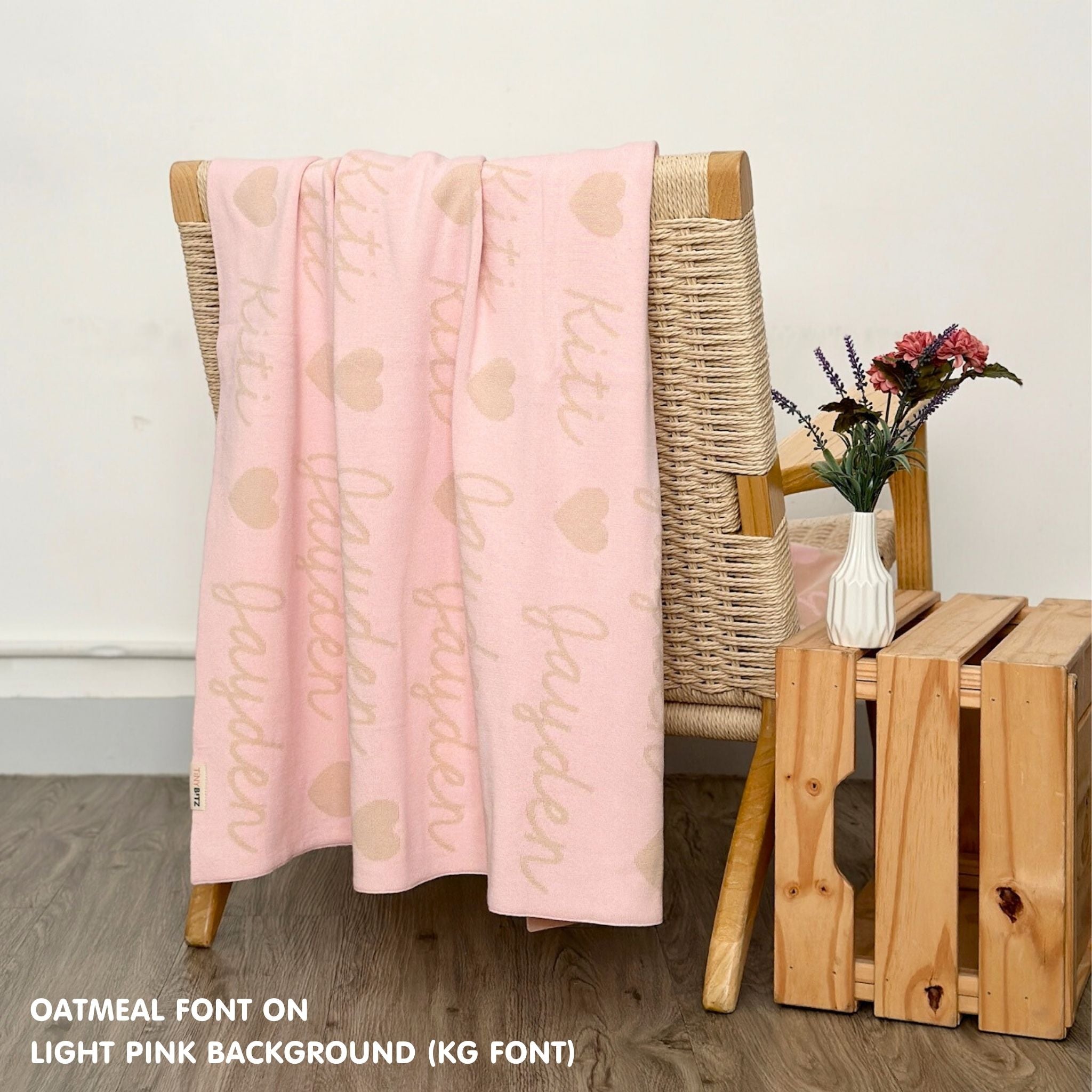 Personalized blanket with couple's name knitted in light pink and oatmeal, made by TinyBitz.