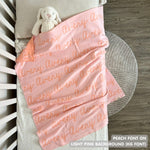 Cotton baby blanket with baby's name knitted in light pink and peach, made by TinyBitz.