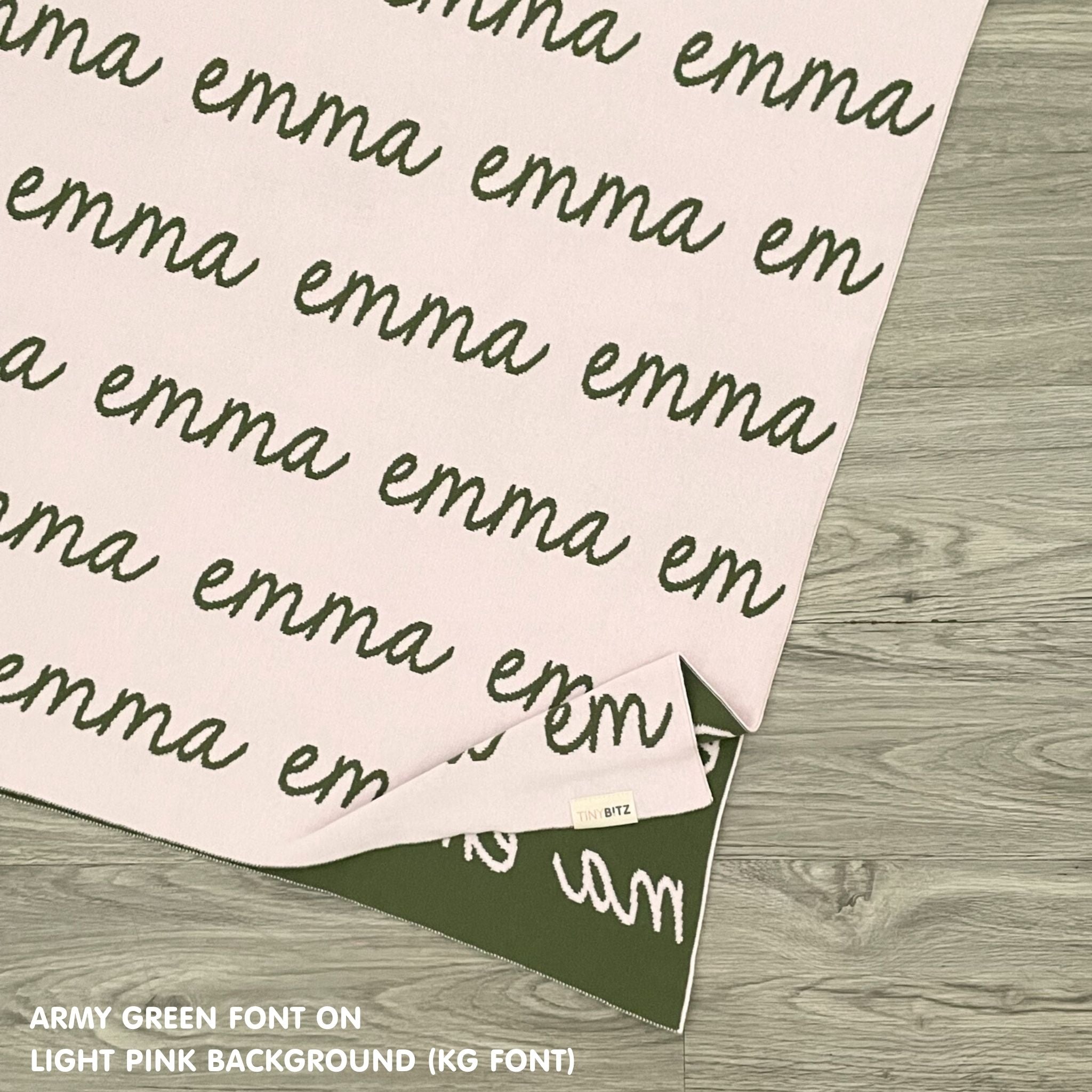 Customisable blanket with adult's name knitted in light pink and army green, personalized by TinyBitz.