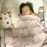 TinyBitz knitted name blanket in light pink and light grey can be used to decorate your baby's room!