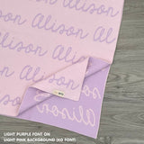 Customisable blanket with adult's name knitted in light pink and light purple, personalized by TinyBitz.