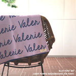 Custom name blanket in light purple and blue draped over a chair makes the best personalized home decor.