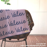 Custom name blanket in light purple and blue draped over a chair makes the best personalized home decor.