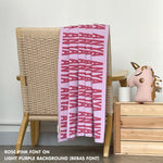 Customisable blanket with adult's name knitted in light purple and rose pink, personalized by TinyBitz.