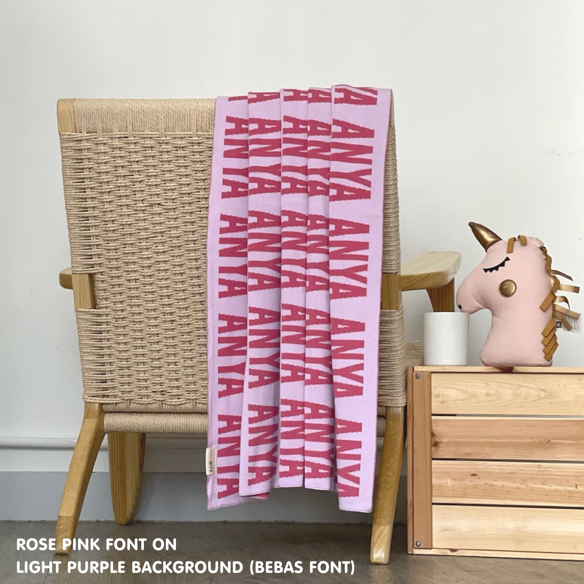 Customisable blanket with adult's name knitted in light purple and rose pink, personalized by TinyBitz.