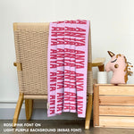 TinyBitz knitted baby boy blanket in light purple background and rose pink, personalized with your baby’s name.