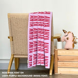 TinyBitz knitted baby boy blanket in light purple background and rose pink, personalized with your baby’s name.