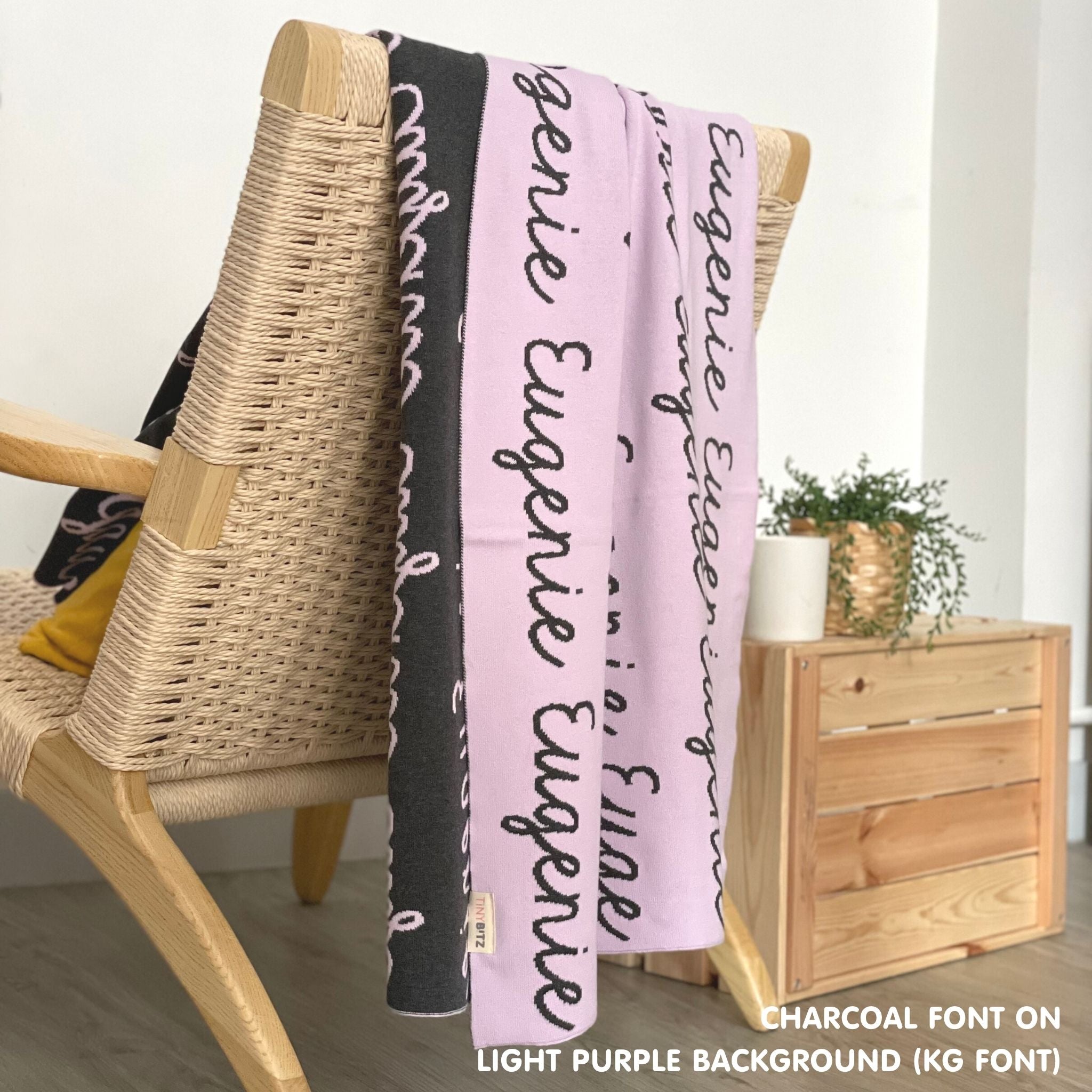 Customisable blanket with adult's name knitted in light purple and charcoal, personalized by TinyBitz.