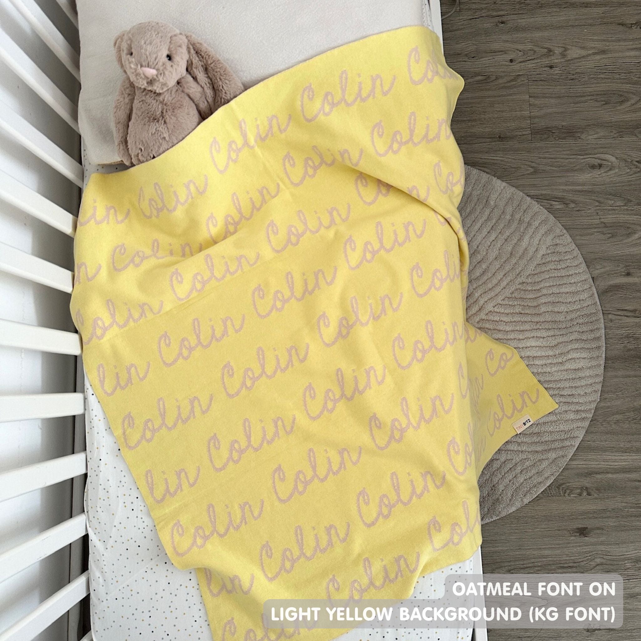 TinyBitz knitted baby boy blanket in light yellow background and oatmeal, personalized with your baby’s name.