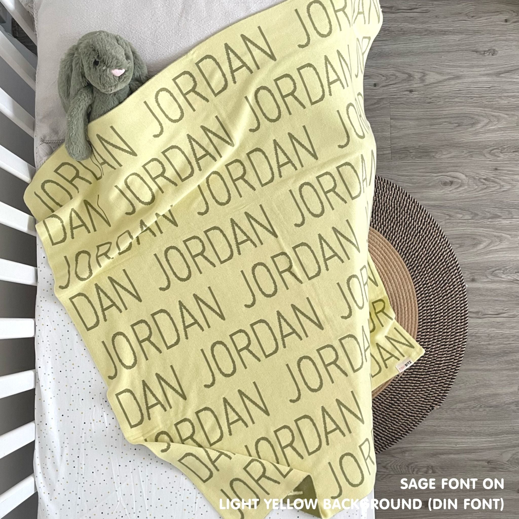 TinyBitz personalized knitted blanket in light yellow background, customized with baby's name and made from 100% cotton.