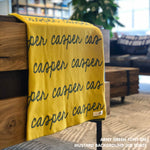 Personalised pet blanket in mustard and army green knitted cotton, custom dog blanket by TinyBitz, styled on modern wooden dog bed.
