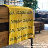 Personalised pet blanket in mustard and army green knitted cotton, custom dog blanket by TinyBitz, styled on modern wooden dog bed.