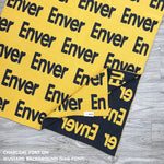 Baby blanket knitted from cotton personalized with baby's name in mustard and charcoal, made by TinyBitz.