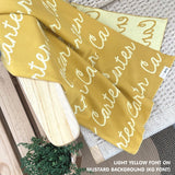 Cotton baby blanket with baby's name knitted in mustard and light yellow, made by TinyBitz.