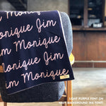 Custom name blanket in navy and light purple draped over a chair makes the best personalized home decor.