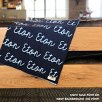 Custom name blanket in navy and light blue draped over a chair makes the best personalized home decor.