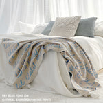 Custom name blanket draped on bed, knitted in oatmeal and sky blue makes the best personalised home decor.