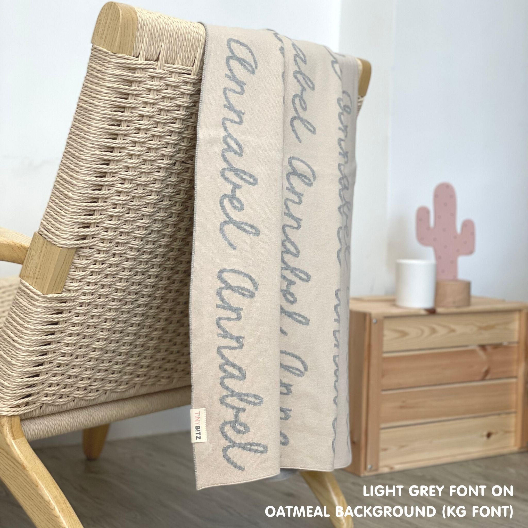Customisable blanket with adult's name knitted in oatmeal and light grey, personalized by TinyBitz.