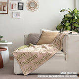 Customisable sofa throw and blanket with your own name knitted in oatmeal and sage, made by TinyBitz!