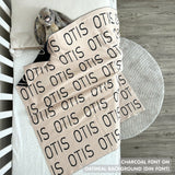 TinyBitz Personalized baby knitted name blanket in oatmeal and charcoal, making the best baby shower gift!