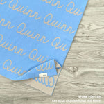 Customisable blanket with adult's name knitted in sky blue and stone, personalized by TinyBitz.